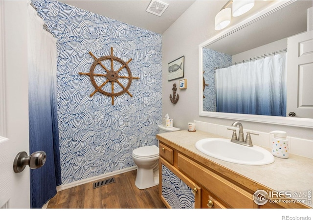 full bath with wood finished floors, toilet, and vanity