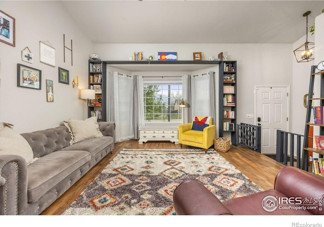 living area with wood finished floors and a chandelier