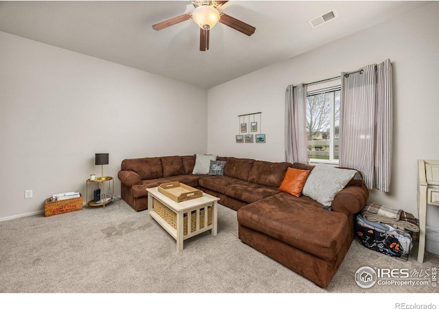 carpeted living room with a ceiling fan and baseboards