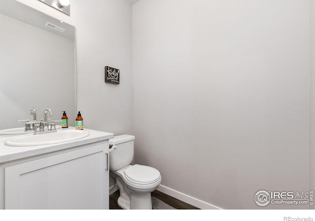 602 Santa Fe Trl Unit D1, Ault, CO 80610 - half bathroom with vanity, toilet, and baseboards