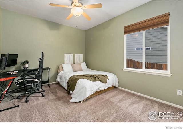 bedroom featuring carpet flooring, baseboards, an office area, and a ceiling fan