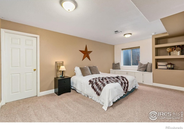 bedroom featuring carpet and baseboards