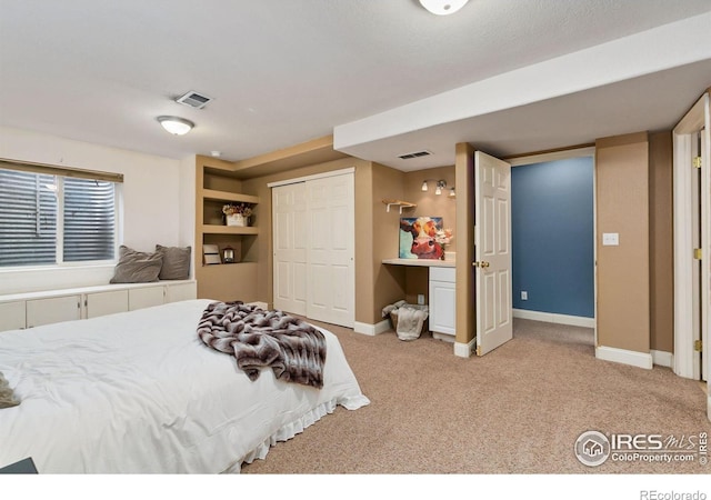 carpeted bedroom with baseboards and a closet