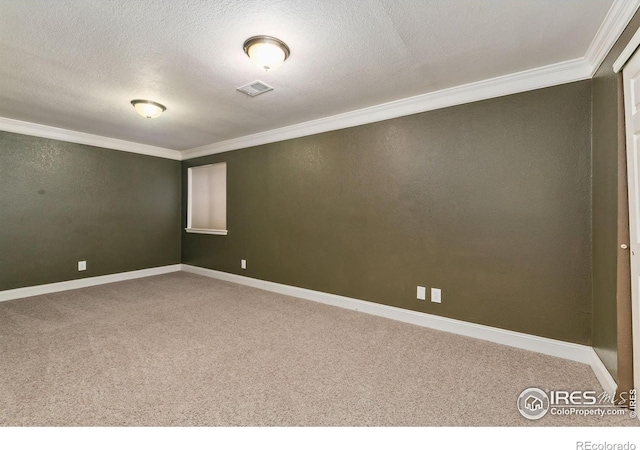 spare room with ornamental molding, carpet flooring, baseboards, and a textured ceiling