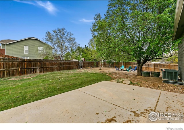 view of yard with central AC unit and a patio area