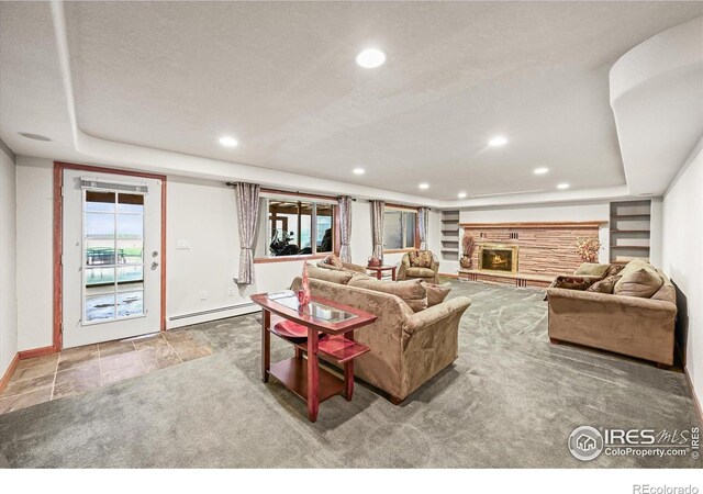 14531 Country Hills Dr, Brighton, CO 80601 - living area with a baseboard heating unit, recessed lighting, baseboards, a fireplace, and a raised ceiling