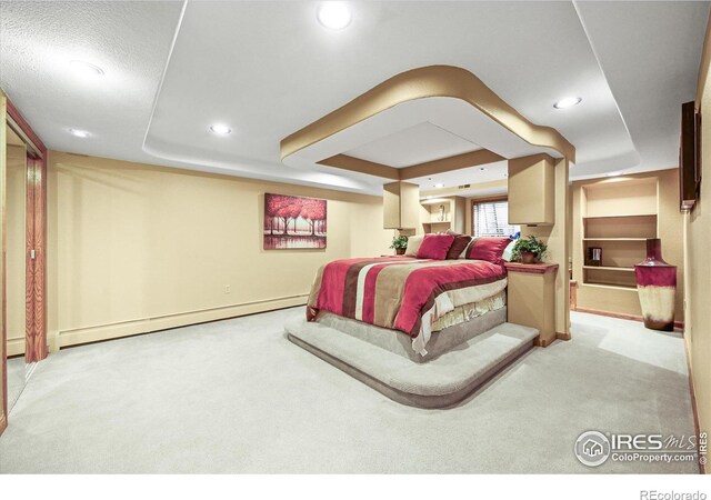 14531 Country Hills Dr, Brighton, CO 80601 - bedroom featuring carpet floors, a baseboard heating unit, a tray ceiling, recessed lighting, and baseboards
