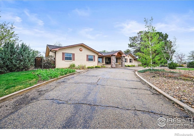 14531 Country Hills Dr, Brighton, CO 80601 - ranch-style home with brick siding, asphalt driveway, and fence