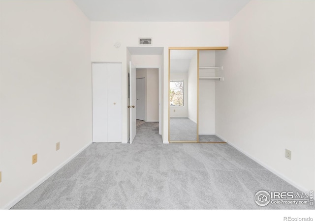 3260 47th St Unit 207A, Boulder, CO 80301 - unfurnished bedroom with carpet floors, baseboards, and two closets