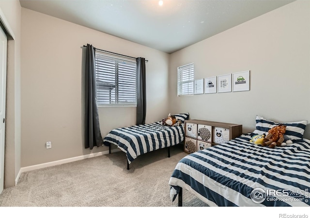 bedroom with carpet and baseboards