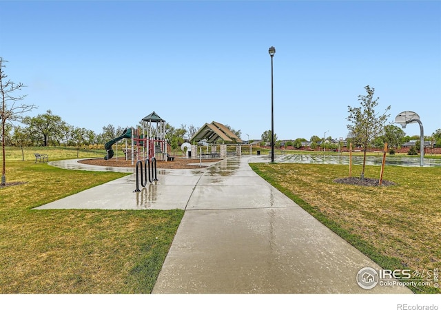 view of community featuring a yard and a water view