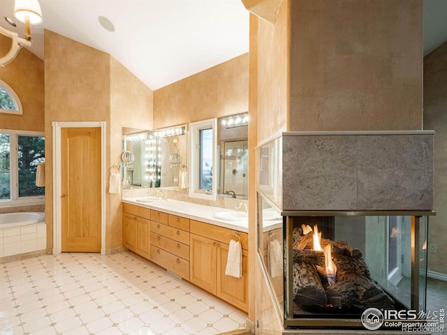 full bathroom with high vaulted ceiling, a bath, and double vanity