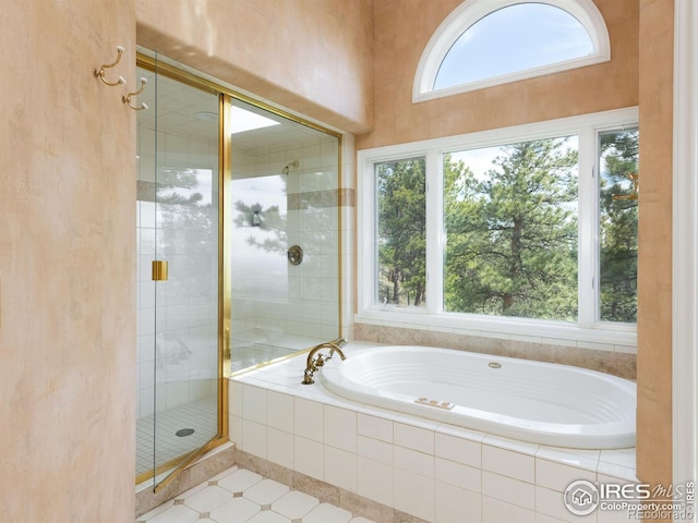 full bathroom with a shower stall and a garden tub