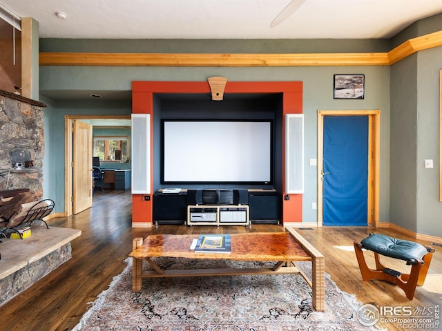 cinema room with wood finished floors and baseboards