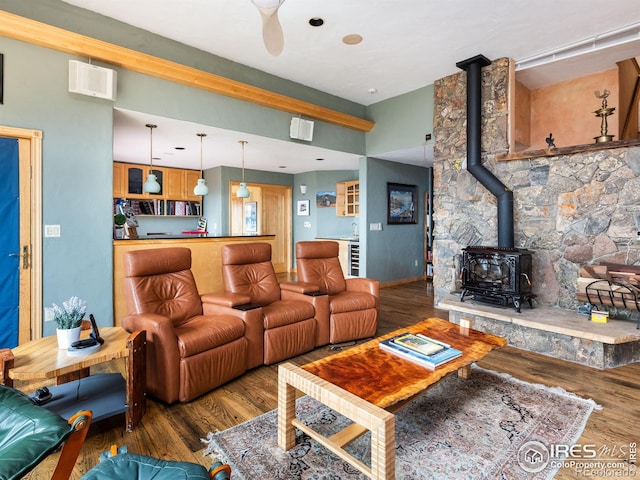 living area featuring a wood stove and wood finished floors