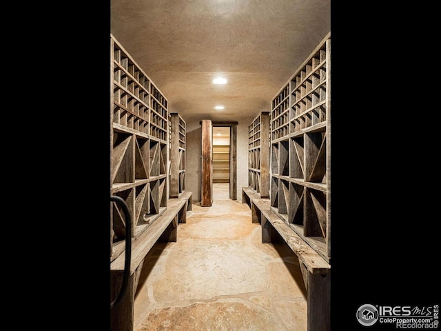 wine room featuring a textured ceiling