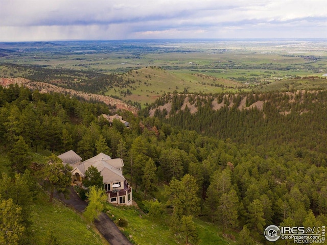 aerial view of property's location featuring a forest