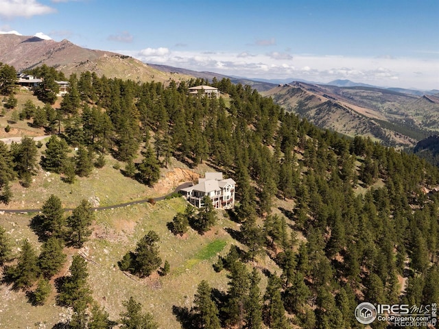 aerial overview of property's location featuring mountains and a heavily wooded area