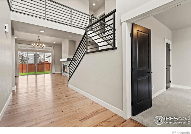 1940 Rolling Wind Dr, Windsor, CO 80550 - entrance foyer with baseboards, a chandelier, stairs, light wood finished floors, and recessed lighting