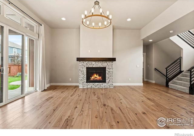 1940 Rolling Wind Dr, Windsor, CO 80550 - unfurnished living room with light wood-style floors, baseboards, a chandelier, stairs, and recessed lighting