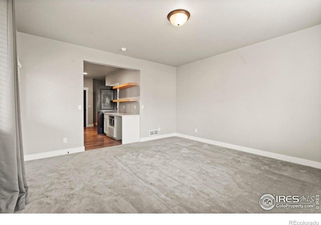 1940 Rolling Wind Dr, Windsor, CO 80550 - unfurnished living room with carpet floors and baseboards