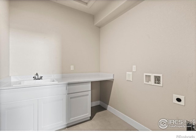 1940 Rolling Wind Dr, Windsor, CO 80550 - washroom with washer hookup, hookup for an electric dryer, light tile patterned flooring, baseboards, and cabinet space