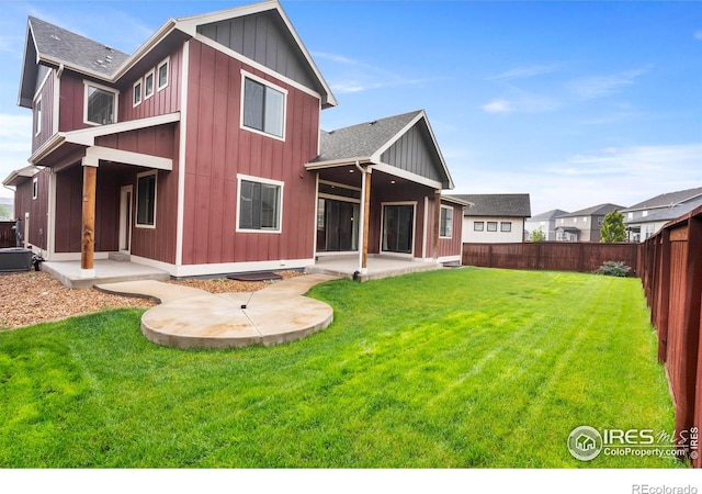 1940 Rolling Wind Dr, Windsor, CO 80550 - rear view of property with a patio area, board and batten siding, roof with shingles, and central air condition unit