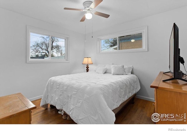 bedroom featuring wood finished floors, baseboards, and ceiling fan