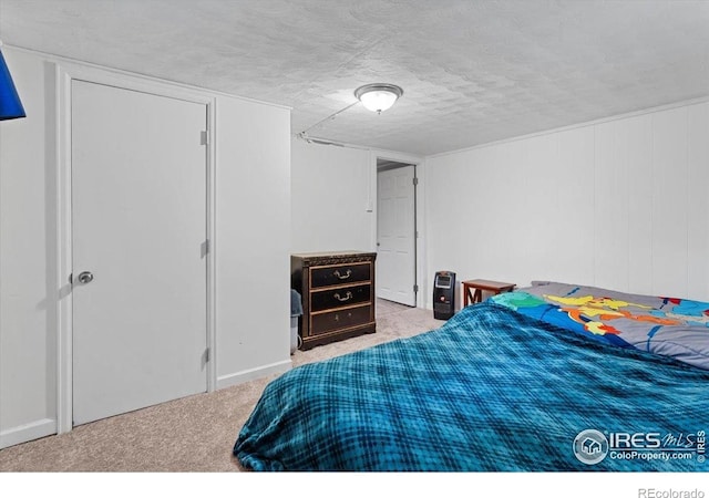 carpeted bedroom featuring a textured ceiling