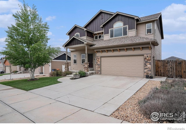 6725 2nd St, Frederick, CO 80530 - craftsman house featuring board and batten siding, fence, a garage, driveway, and stone siding