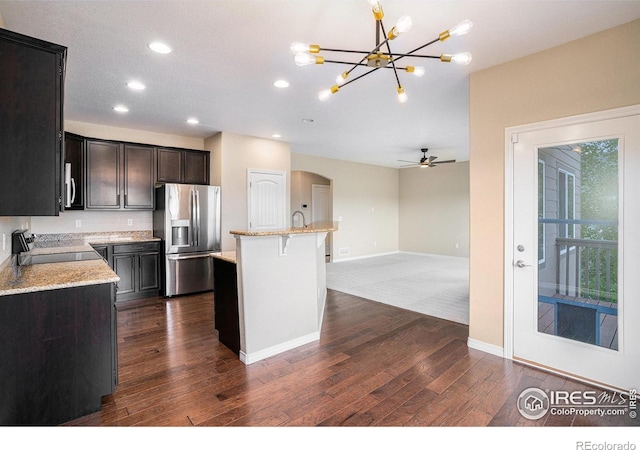 6725 2nd St, Frederick, CO 80530 - kitchen with stainless steel fridge with ice dispenser, range with electric stovetop, a chandelier, recessed lighting, and arched walkways