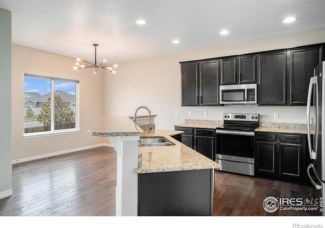 6725 2nd St, Frederick, CO 80530 - kitchen featuring stainless steel appliances, a sink, dark wood-style floors, baseboards, and recessed lighting