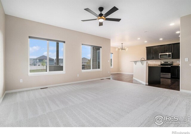 6725 2nd St, Frederick, CO 80530 - unfurnished living room featuring carpet floors, a chandelier, recessed lighting, baseboards, and ceiling fan