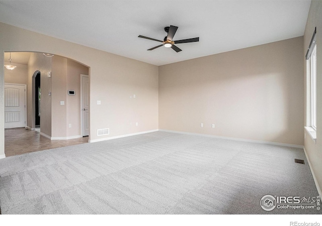 6725 2nd St, Frederick, CO 80530 - spare room featuring carpet flooring, a ceiling fan, arched walkways, and baseboards