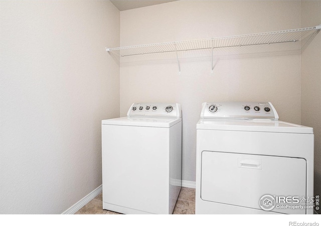 6725 2nd St, Frederick, CO 80530 - laundry area with washer and clothes dryer, baseboards, and light tile patterned floors