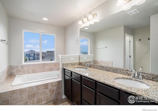 6725 2nd St, Frederick, CO 80530 - bathroom with a bath, double vanity, tile patterned floors, and recessed lighting