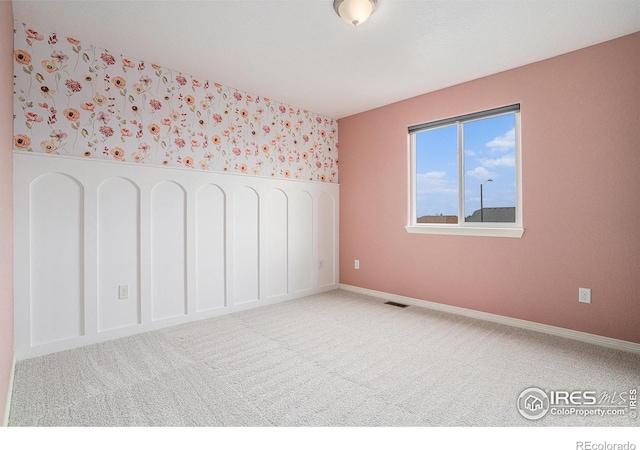 6725 2nd St, Frederick, CO 80530 - spare room with wallpapered walls, carpet, and baseboards