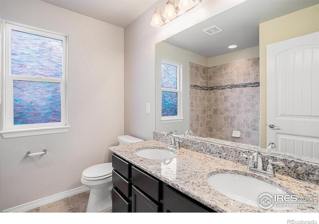 6725 2nd St, Frederick, CO 80530 - bathroom with toilet, baseboards, double vanity, tile patterned floors, and a shower
