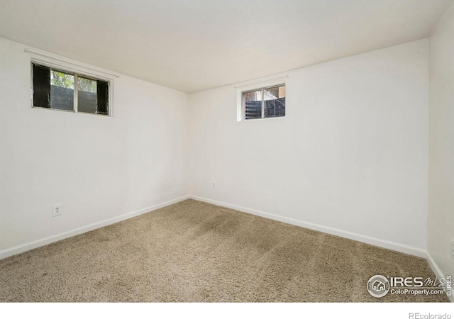 empty room with carpet floors and baseboards