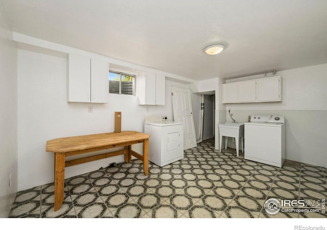 laundry room featuring cabinet space, light floors, and washer and dryer