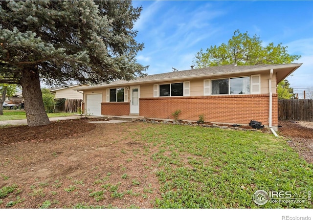 3020 Sunset Dr, Evans, CO 80620 - ranch-style home featuring brick siding, an attached garage, and driveway