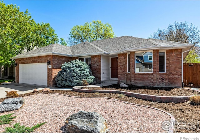 2072 Skylark Ct, Longmont, CO 80503 - ranch-style home with brick siding, a garage, fence, driveway, and roof with shingles