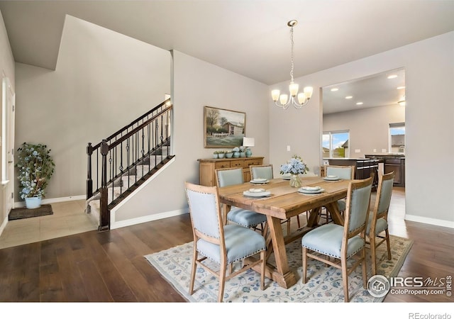 dining area with wood finished floors, a chandelier, stairway, baseboards, and recessed lighting