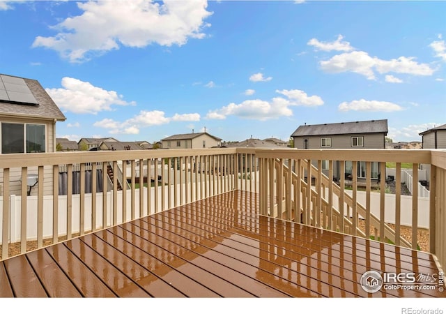 wooden terrace with a residential view and stairs
