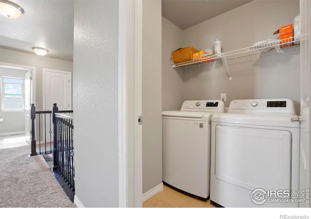 laundry room with separate washer and dryer and baseboards