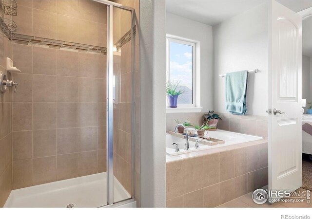 full bathroom with a shower stall, ensuite bathroom, and a bath