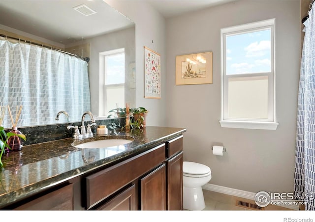full bath featuring tile patterned flooring, toilet, vanity, and baseboards