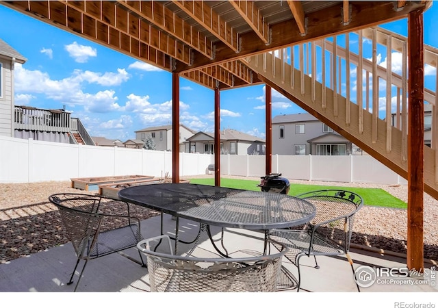 view of patio / terrace featuring outdoor dining area and a residential view