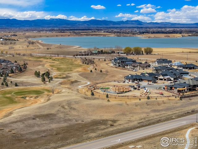 aerial perspective of suburban area featuring a water and mountain view