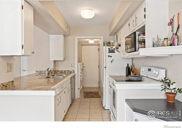 4160 Monroe Dr Unit B, Boulder, CO 80303 - kitchen with white range with electric stovetop, a sink, washing machine and clothes dryer, and white cabinetry